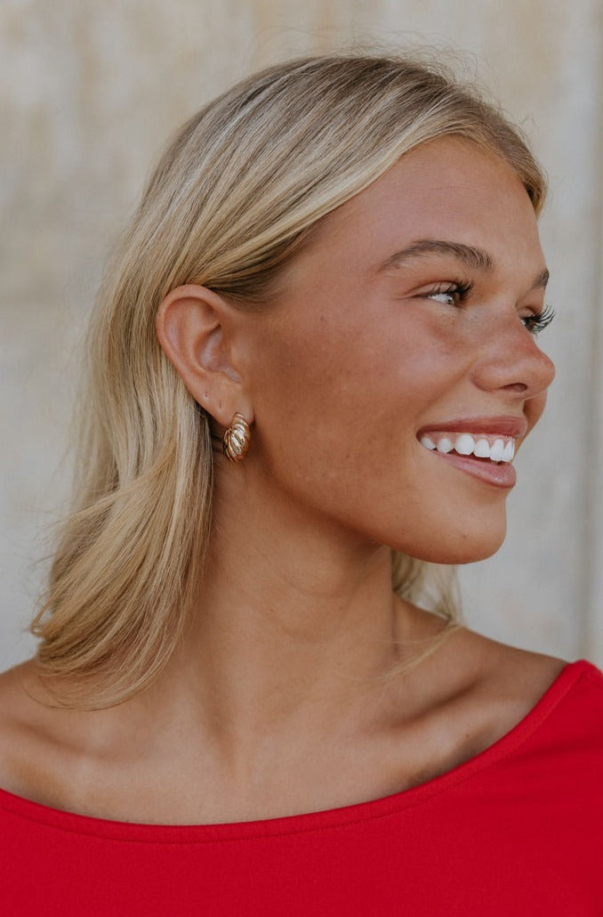 Model is shown from a side view. Model is wearing the Bette Croissant Hoops.