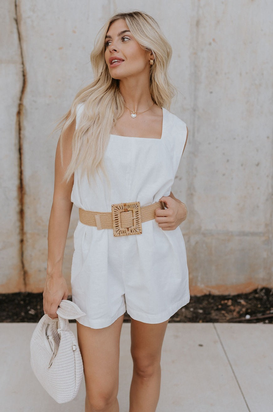 Front view of female model wearing the Teagan White Square Neckline Romper which features White Linen Fabric, White Lining. Square Neckline, Sleeveless and Monochrome Back Zipper with Hook Closure