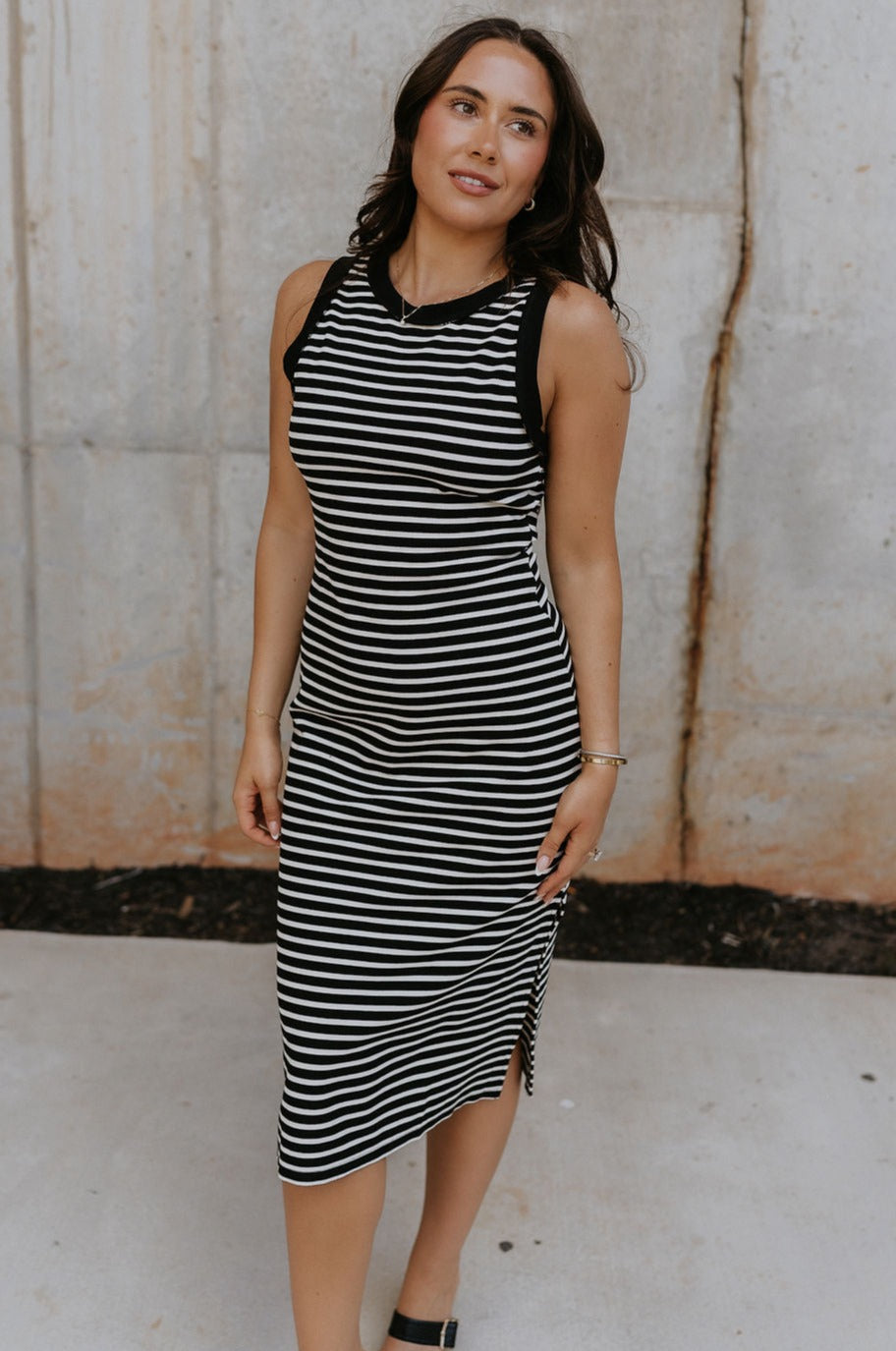 Fro\nt view of female model wearing the Andri Black & White Stripe Midi Dress which features Black and Cream Stripe Pattern, Midi Length, Slits On Each Side, Round Neckline and Sleeveless