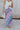 Front view of female model wearing the Lily Aqua & Pink Multi Pleated Maxi Skirt which features Blue, Pink, Red, Purple and Aqua Floral Print, Satin Pleated Fabric, Maxi Length, Light Blue Lining and Side Zipper with Hook Closure