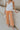 Front view of female model wearing the Kennedy Apricot Orange Wide Leg Pants which features Orange Denim Stretch Fabric, Cropped Wide Pant Leg, Front Zipper with Button Closure, Belt Loops, Two Front Pockets andTwo Back Pockets