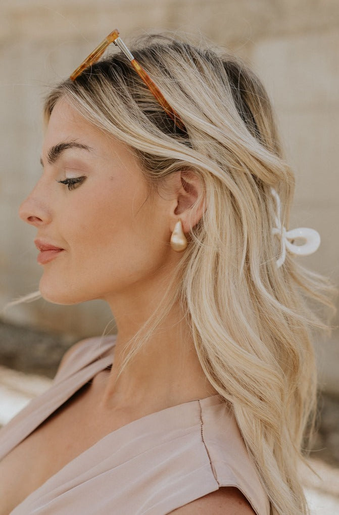 Side view of model wearing the Liza Gold Earrings.