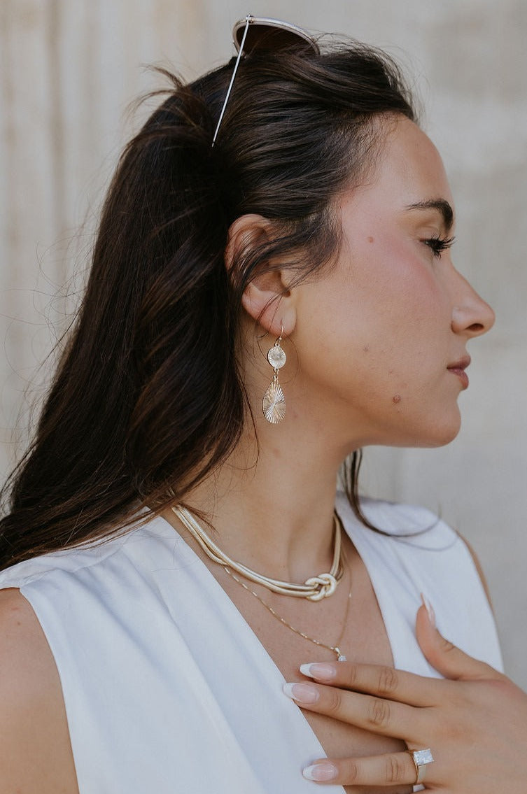Side view of model wearing the Rowan Gold Earrings.