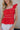 Close up of Kelly Red Ruffle Tank that has linen tie details and ruffle details throughout, zipper on back.
