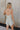 Back view of Alyssa Floral Romper that is light blue and cream, with a V neckline, spaghetti straps, and mini length.