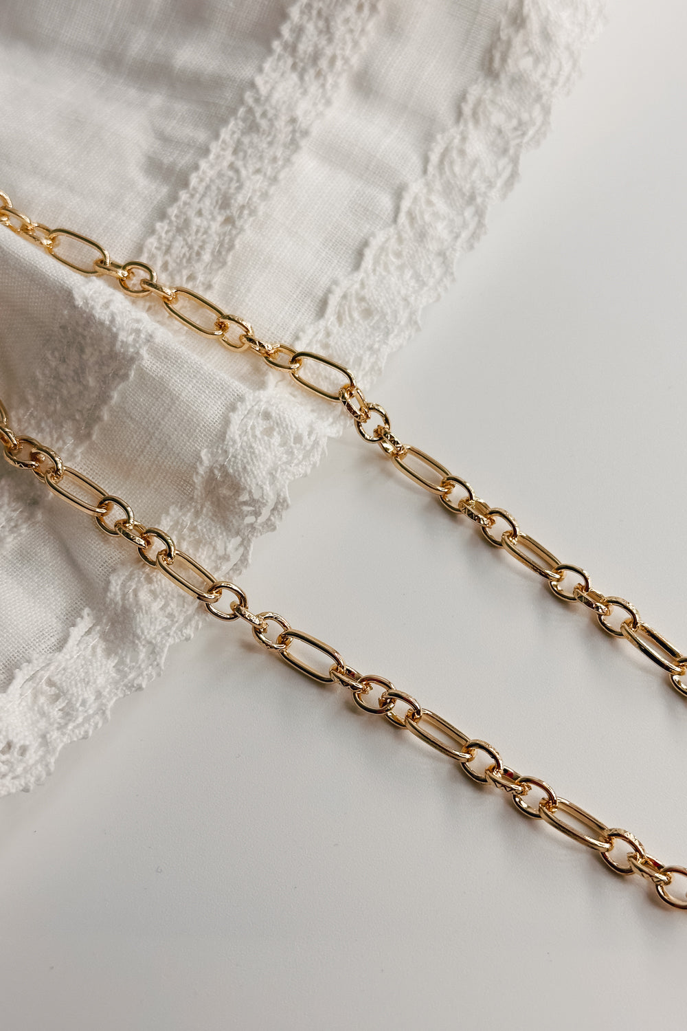 Image shows the Kennedy Gold Chain Link Necklace against a white background. Necklace has gold circle and oval links. Shown without charms.