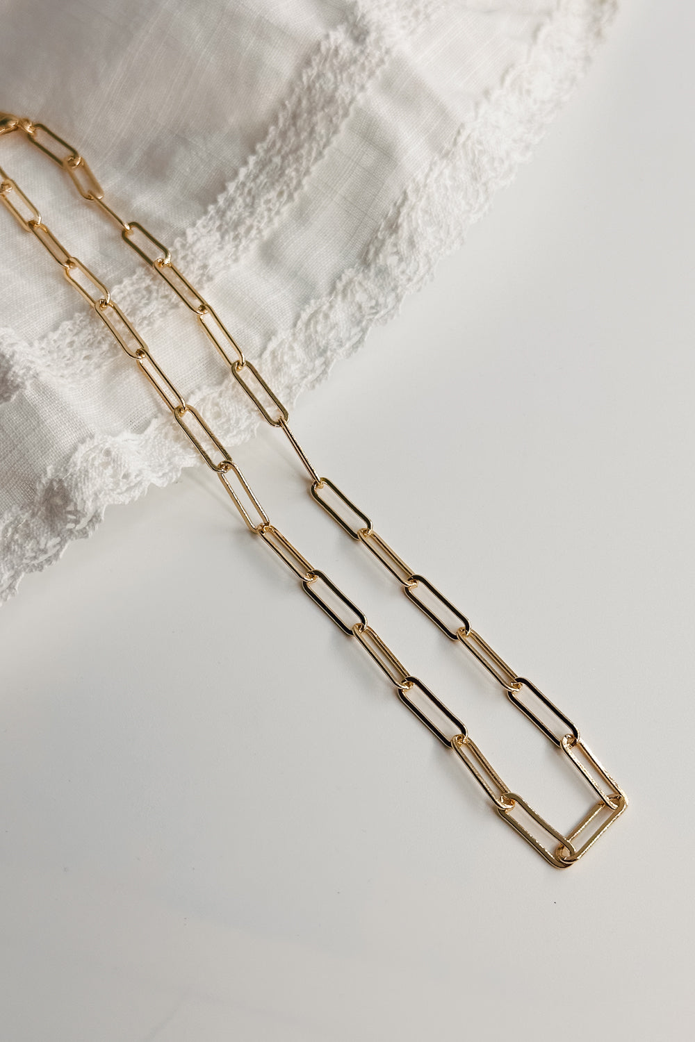 Image shows the Maria Gold Oval Chain Link Necklace against a white background. Necklace has gold oval links. Shown without charms.