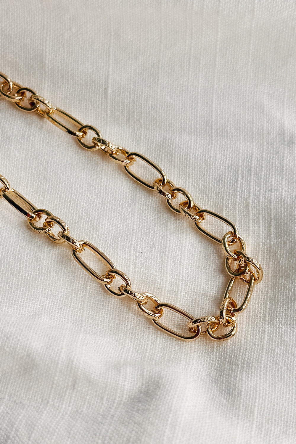 Image shows a close-up of the Reagan Gold Chain Link Bracelet against a white background. Bracelet has gold circle and oval links.