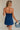 back view of female model wearing the Amaya Strapless Flare Mini Dress which features Lightweight Fabric, Side Zipper Closure, Belt Loops, Two Front Pockets, Strapless and Shorts Lining. the dress is available in red and navy blue