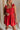 Close up of model wearing Gabby Red Romper. This is a washed red romper with fray details.