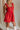 Close up of model wearing Gabby Red Romper. This is a washed red romper with fray details.