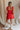 Back view of model wearing Gabby Red Romper. This is a washed red romper with fray details.