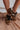 Image shows front and side view of model's legs- model is wearing the Dolce Vita Notice Stitch Sneaker in Dark Leopard.
