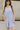 Close up view of model wearing the Ariana Grey Romper. This is a grey romper, sleeveless, with pockets.