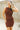 Close up view of model wearing the Laila Mini Sweater Dress in chestnut. This is a sweater mini dress, sleeveless, comes in either black or chestnut.