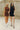 Close up view of models wearing the Laila Mini Sweater Dress in black and chestnut. This is a sweater mini dress, sleeveless, comes in either black or chestnut.