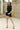 Full body view of model wearing the Laila Mini Sweater Dress in black. This is a sweater mini dress, sleeveless, comes in either black or chestnut.