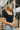 Close up of model wearing the Kendra Square Neck Padded Bodysuit in black. This is a bodysuit with a square neckline, thong button closure, and short sleeves., comes in either black or white.