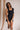Model is pictured wearing the Tianna Romper in a size small.