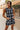 Front upper body view of female model wearing the Mackenzie Black & White Romper with front pockets