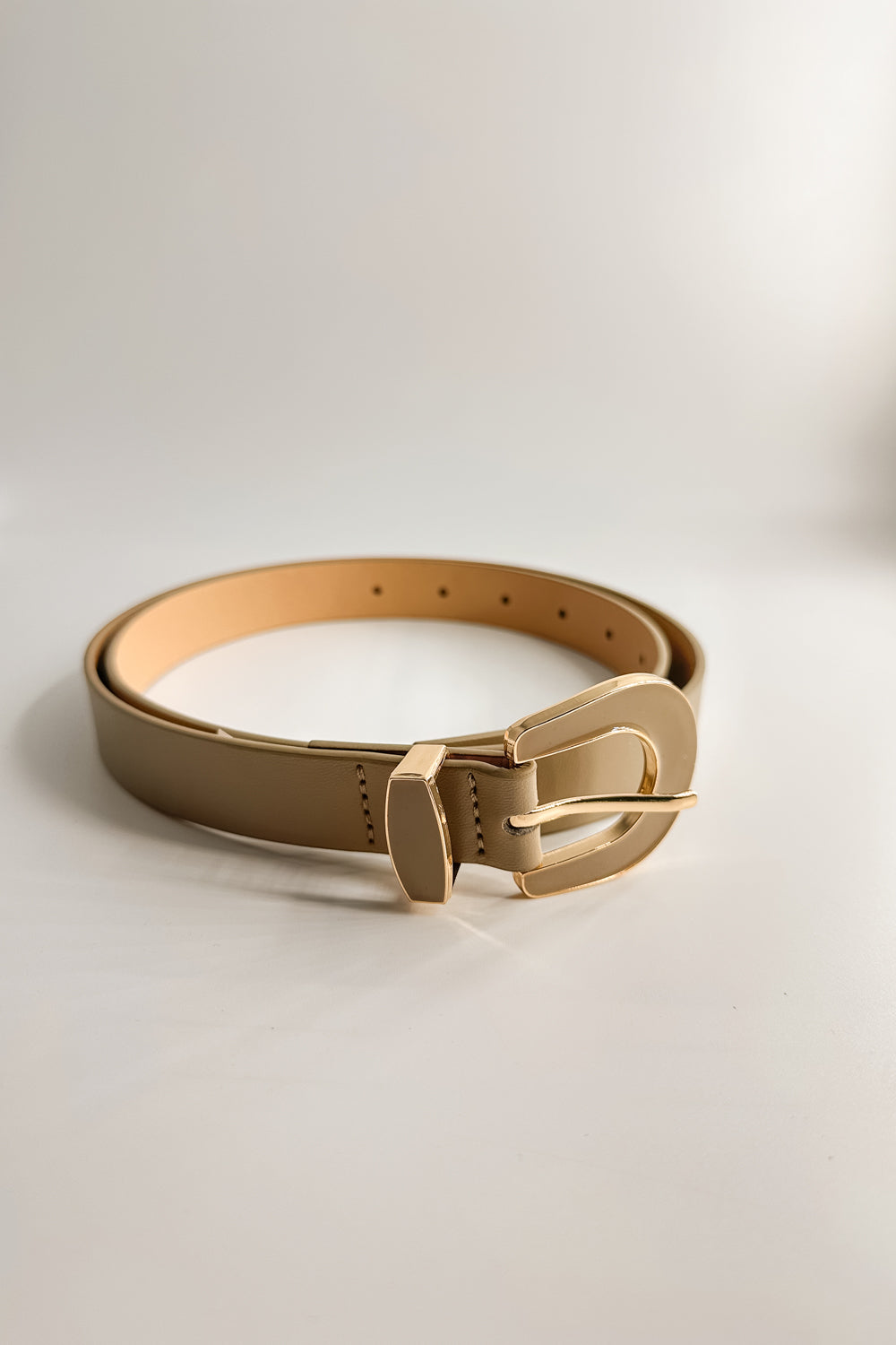 Flat Lay view of the Lucia Taupe Western Adjustable Belt which features aupe Leather Fabric, Gold Adjustable Buckle and Gold Western Detail