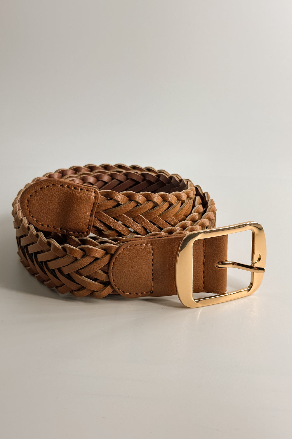 Front view of the Everly Braided Adjustable Belt in Brown  which features brown Leather Fabric, Braided Details, Gold Adjustable Buckle