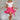 Full body side view of female model wearing the Gabriella Pink Ruffle Mini Skort which features Pink Lightweight Fabric, Pink Shorts Lining, Ruffle Pleated Hem Details and Side Tie Detail