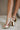 image shows side view of model's legs; model is wearing the Adina Metallic Heels in Gold