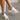 Side view of female model wearing the Venti Iris Sandal in White which features White Fabric Upper, Mesh Stripe Details,  Slide On Style, Memory Foam Footbed, 2.25 Inch Platform Wedge and Flexible Rubber Outsole