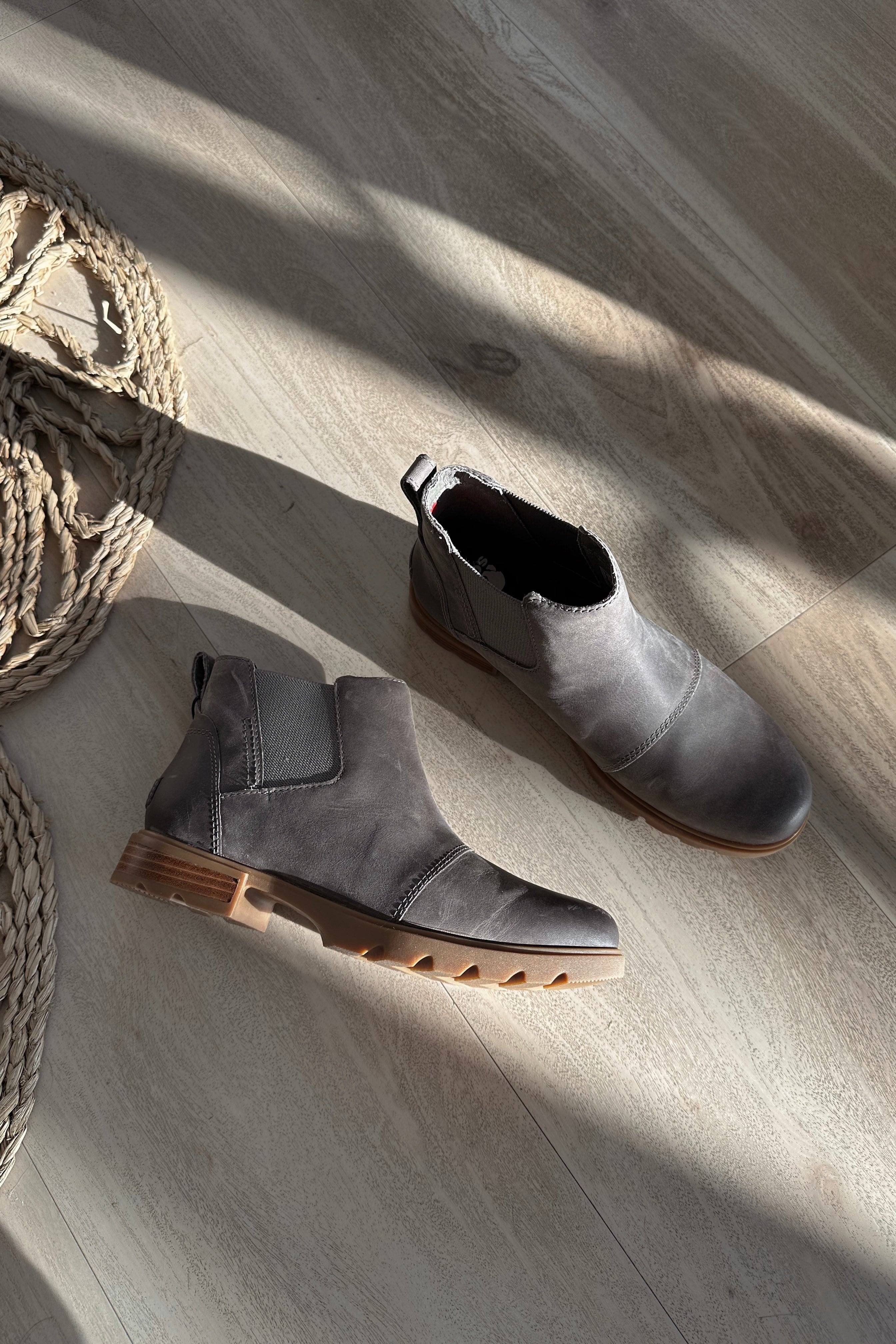 Ariel view of the Emelie III Chelsea Bootie which features grey lightweight waterproof leather upper, side stretch panels, pull tabs, ridged brown sole, 1 inch heel height and 3/4 inch platform height
