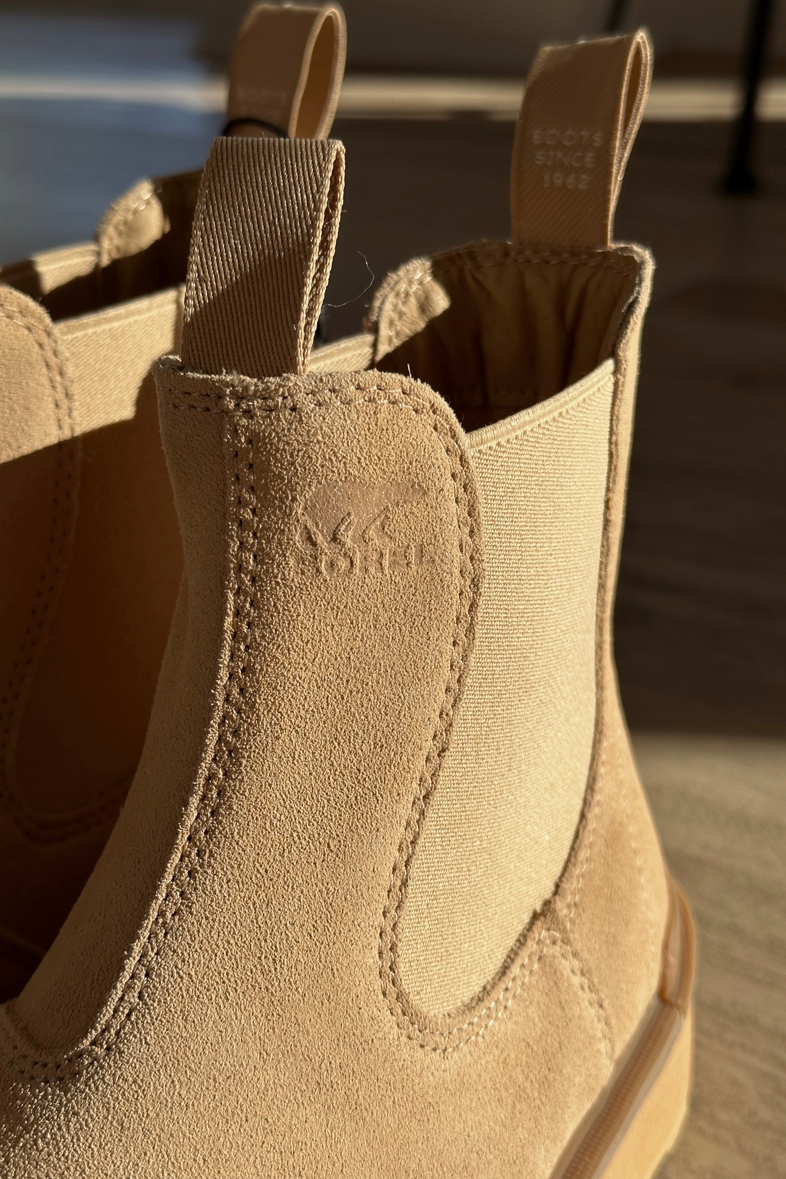 Close up view of the Hi-Line Chelsea Boot in Canoe Ceramic which features tan waterproof suede, monochrome lightweight sole, stretch panels on each side, pull tabs, round toe, 1 inch platform height and 1 inch heel height