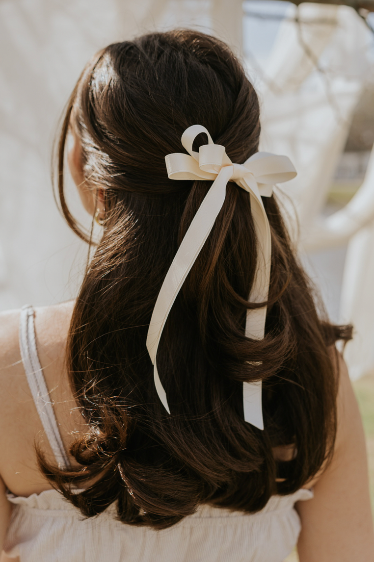 image of model wearing white bow in hair
