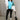 Full body view of model wearing the Ashley Blue Multi Color Block Sweatshirt which features blue, green and white knit fabric, a color block pattern, textured details, a collared neckline with a v-cutout, and long sleeves with elastic cuffs.
