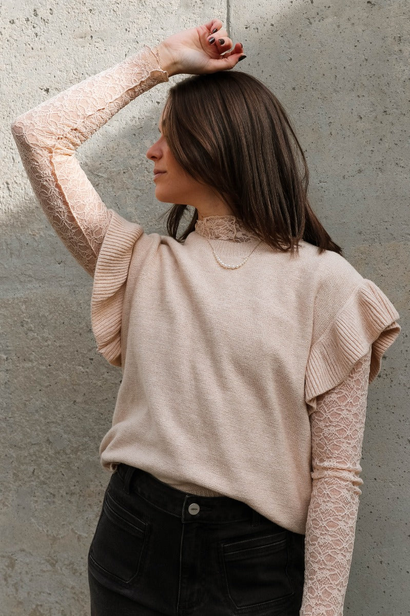 Front view of model wearing the Sierra Beige Knit Ruffle Sweater which features beige knit fabric, a thick hem, a round neckline, and short sleeves with ruffle trim.

