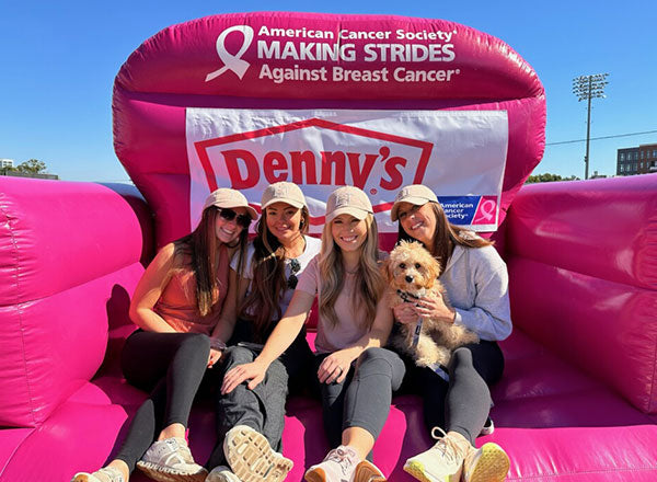 Image of 4 girls at a making strides against breast cancer run.