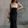 Full body front view of model wearing the Kaliyah Black & Cream Satin Midi Dress that has black, taupe and cream satin fabric, midi length, slits, a colorblock detail, a scoop neck, tie straps, and an open back.