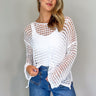 Front view of model wearing the Sahara Ivory Crochet Knit Long Sleeve Sweater which features ivory open knit fabric, a high-low hem, slits on each side, a round neckline and long flare sleeves.