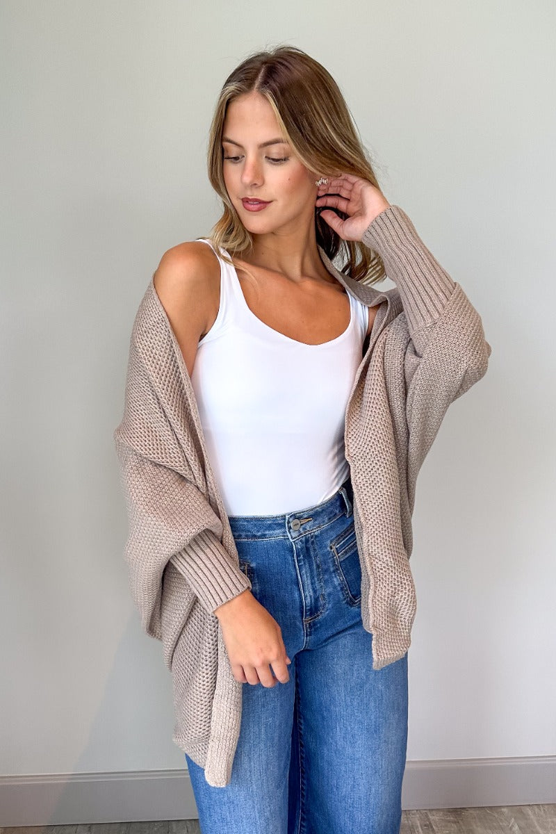 Front view of model wearing the Jennifer Mocha Knit Long Sleeve Open Cardigan which features light mocha knit fabric, front open with no closure, ribbed hem details and long sleeves with cuffs.
