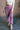 Front view of model wearing the Myla Vintage Purple Drawstring Jogger Pants which features light purple waffle knit fabric, two front pockets, an elastic waistband with drawstring ties, and jogger pant legs with thick hem.