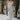 Full body front view of model wearing the Bexley Blue Denim Sleeveless Midi Dress that has light denim wash fabric, a monochrome stitch pattern, a v-neckline, and spaghetti straps.