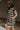 Side view of model wearing the Esme Black & Cream Striped Dress which features black and cream ribbed fabric, striped pattern, mini length, two side pockets, round neckline and short sleeves.