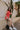 image of model wearing The Emily Washed Red Denim Sleeveless Romper features washed red denim fabric, two front pockets, silver button details, button-up front, two front chest buttoned pockets, two back pockets, a collared neckline and a sleeveless desi