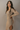 Side view of model wearing the Adeline Khaki Ribbed Long Sleeve Midi Dress which features khaki ribbed fabric, midi length, slits on each side, a square neckline, and long sleeves.
