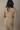 Back view of model wearing the Adeline Khaki Ribbed Long Sleeve Midi Dress which features khaki ribbed fabric, midi length, slits on each side, a square neckline, and long sleeves.