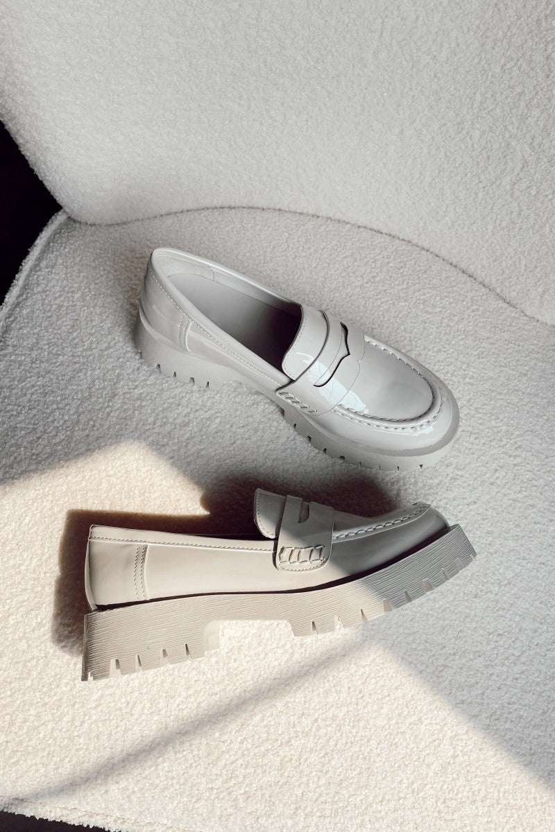 Aerial view of the Blair Patent Loafers that have ivory patent faux-leather uppers and platform lug soles. 