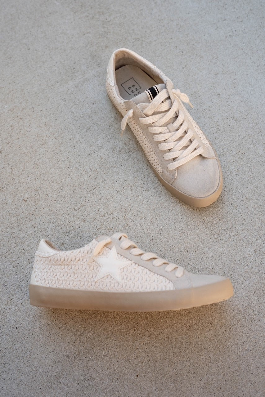 Ariel view of Paula Sneaker in Bone Woven. Flat sole, pre-tied lace up details, monochrome woven details and white star detail.