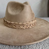 Close Front view of the Briley Camel Suede Brimmed Hat that has camel-colored suede material, a flat brim, braided band details, and inner tie size adjusters.