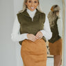Front view of model wearing the Static Radio Skirt in Cognac that has cognac suede fabric, stitched details, a mini length hem, and an elastic waistband.