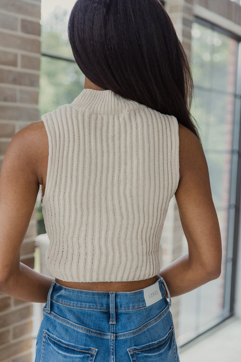 Back view of model wearing the I Go Back Tank in Natural which features cream chenille knit fabric, a high neckline and a sleeveless design.