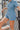 Frontal View of the Heading South Romper that features a blue colored material, a collar neckline, a short cuffed sleeve, a button-up front, two front pockets at the chest, a cinched waist, two side pockets, cuffed bottom hem, and two back pockets.